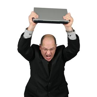 frustrated man holding laptop